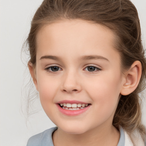 Joyful white child female with medium  brown hair and brown eyes