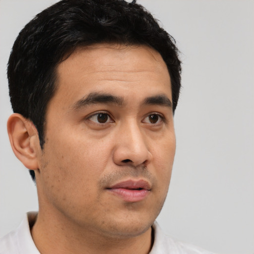 Neutral latino young-adult male with short  black hair and brown eyes