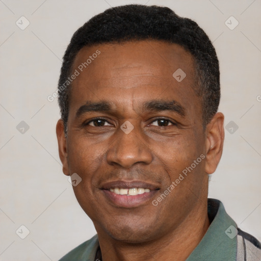Joyful black adult male with short  black hair and brown eyes