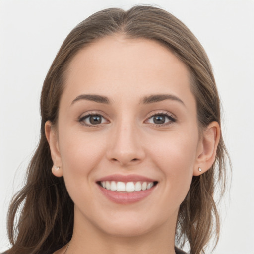 Joyful white young-adult female with long  brown hair and grey eyes