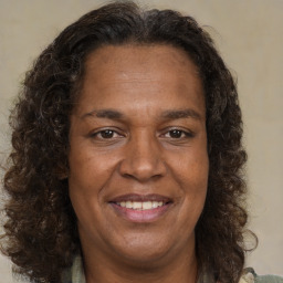 Joyful black adult female with medium  brown hair and brown eyes