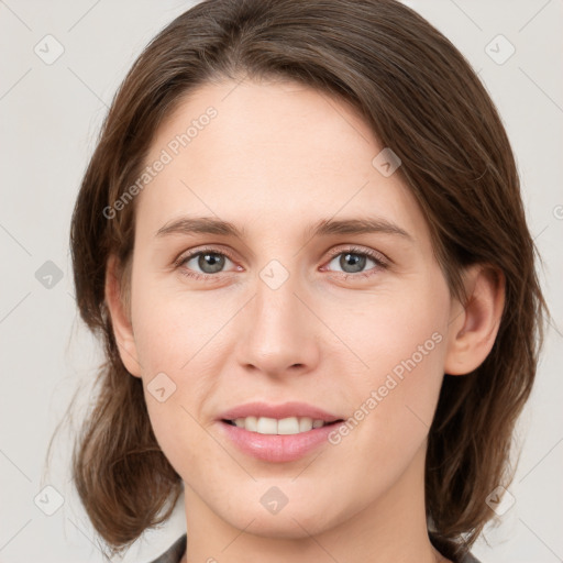 Joyful white young-adult female with medium  brown hair and green eyes