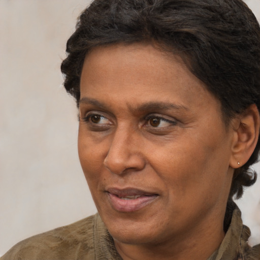 Joyful black adult female with short  brown hair and brown eyes