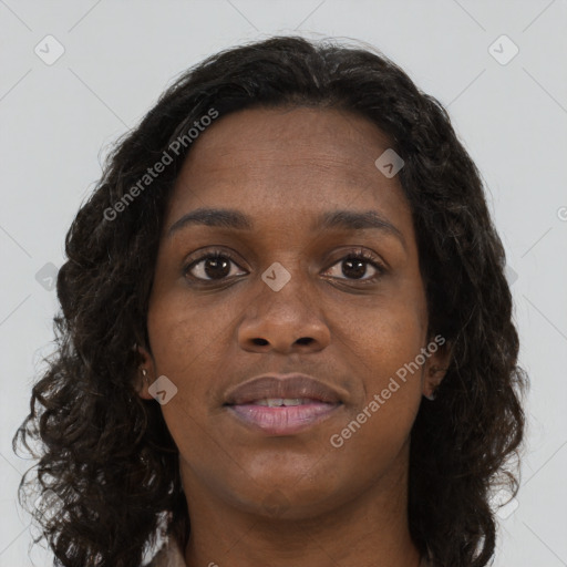 Joyful black young-adult female with long  brown hair and brown eyes