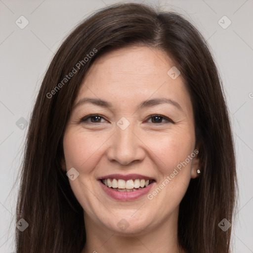 Joyful white adult female with long  brown hair and brown eyes