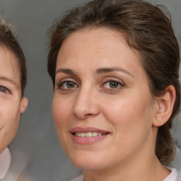 Joyful white adult female with medium  brown hair and brown eyes