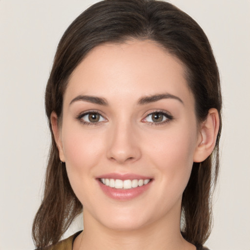 Joyful white young-adult female with long  brown hair and brown eyes