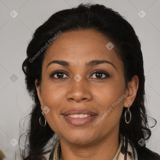 Joyful black adult female with long  brown hair and brown eyes