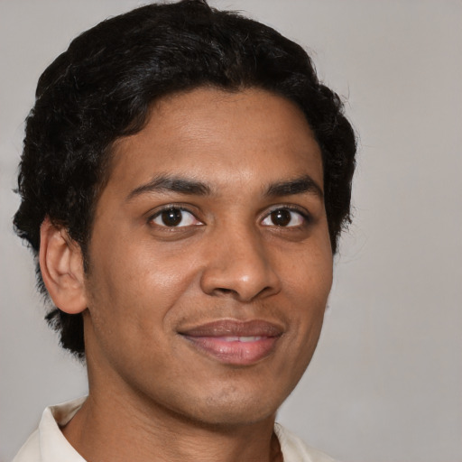 Joyful latino young-adult male with short  brown hair and brown eyes