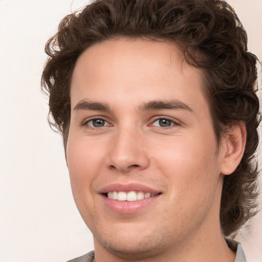 Joyful white young-adult male with medium  brown hair and brown eyes