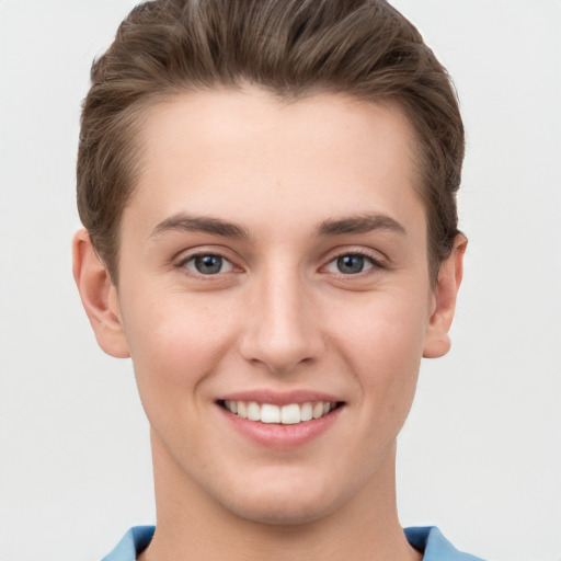 Joyful white young-adult female with short  brown hair and grey eyes