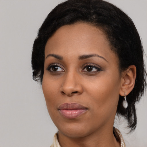 Joyful black young-adult female with medium  black hair and brown eyes