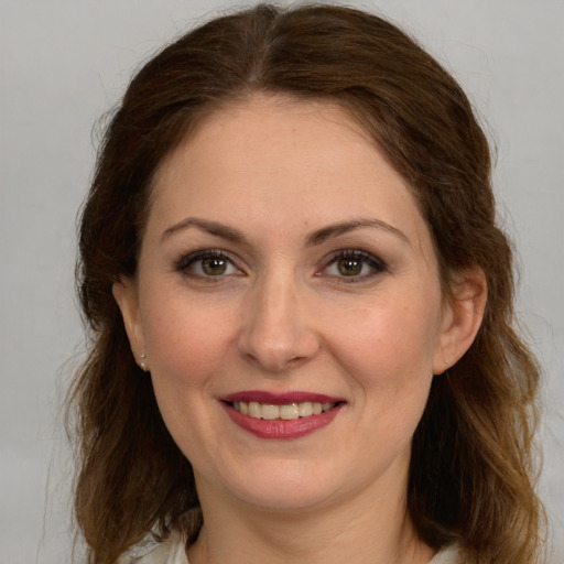 Joyful white young-adult female with long  brown hair and grey eyes