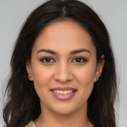 Joyful latino young-adult female with long  brown hair and brown eyes