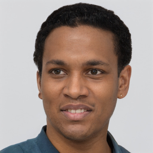 Joyful black young-adult male with short  black hair and brown eyes