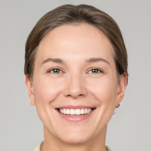 Joyful white adult female with short  brown hair and brown eyes