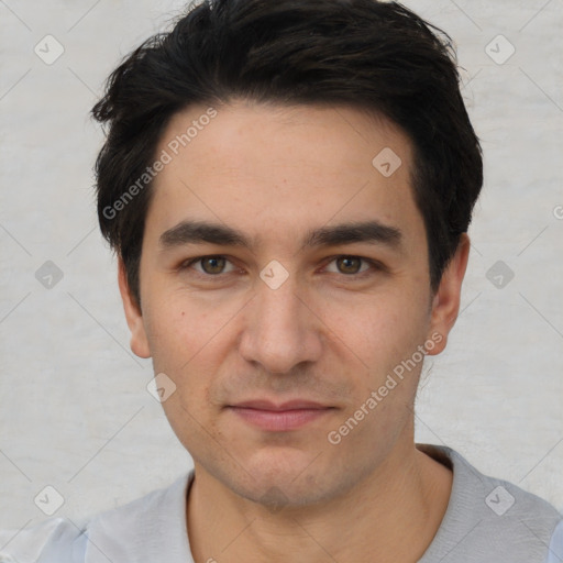 Joyful white young-adult male with short  black hair and brown eyes