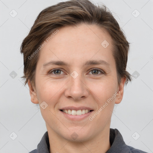 Joyful white young-adult female with short  brown hair and grey eyes