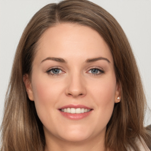 Joyful white young-adult female with long  brown hair and grey eyes