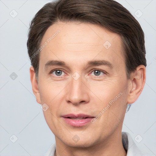 Joyful white adult male with short  brown hair and brown eyes