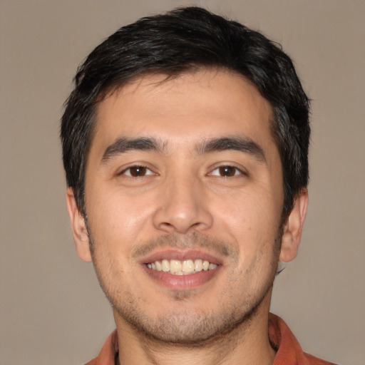 Joyful asian young-adult male with short  black hair and brown eyes