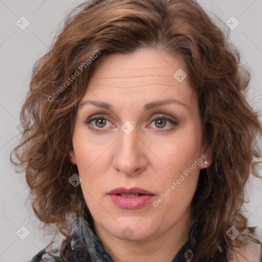 Joyful white adult female with medium  brown hair and blue eyes