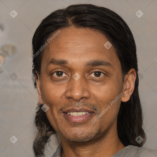 Joyful latino adult male with short  brown hair and brown eyes