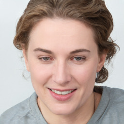 Joyful white young-adult female with medium  brown hair and blue eyes