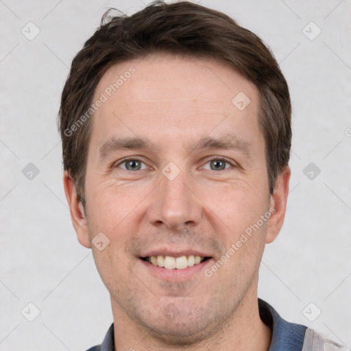 Joyful white adult male with short  brown hair and grey eyes