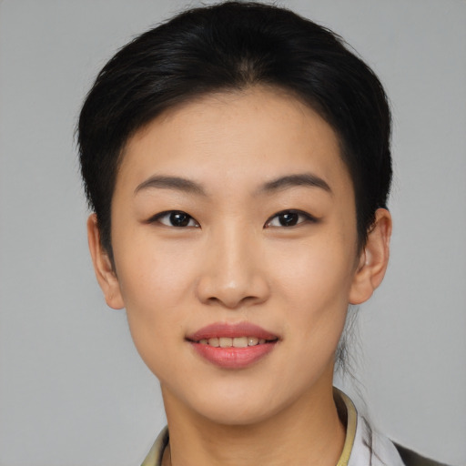 Joyful asian young-adult female with short  brown hair and brown eyes