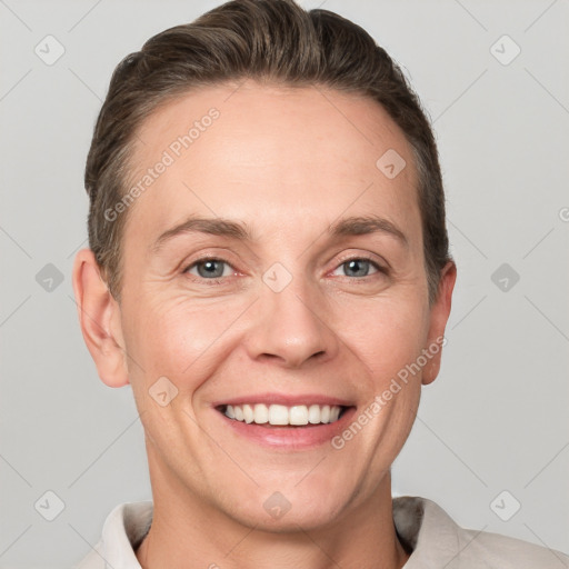 Joyful white adult female with short  brown hair and grey eyes