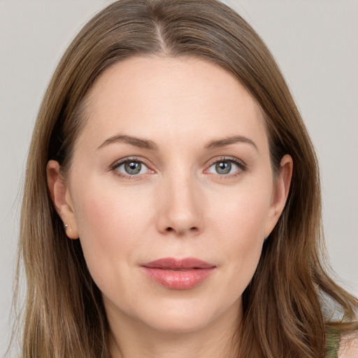 Joyful white young-adult female with long  brown hair and grey eyes