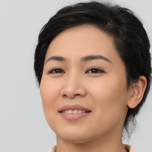 Joyful asian young-adult female with medium  black hair and brown eyes