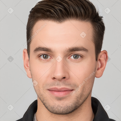 Joyful white young-adult male with short  brown hair and brown eyes