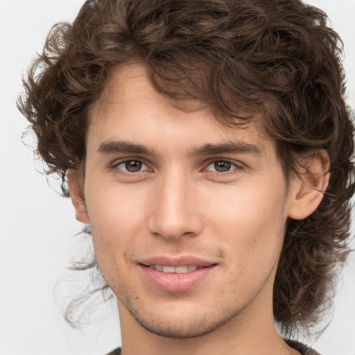 Joyful white young-adult male with medium  brown hair and brown eyes