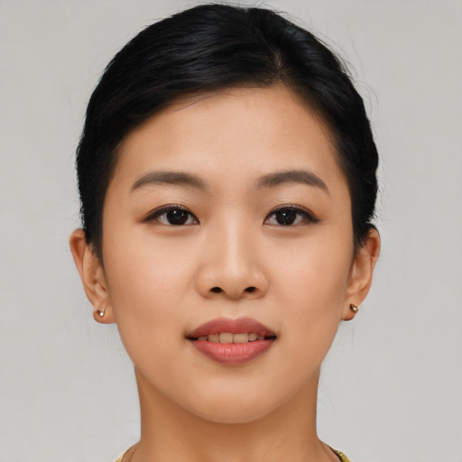 Joyful asian young-adult female with short  black hair and brown eyes