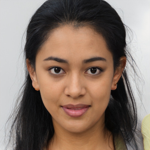 Joyful black young-adult female with long  brown hair and brown eyes