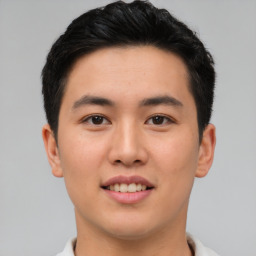 Joyful asian young-adult male with short  brown hair and brown eyes