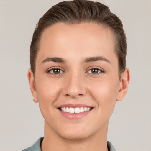 Joyful white young-adult female with short  brown hair and brown eyes