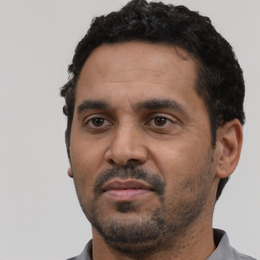 Neutral black adult male with short  black hair and brown eyes