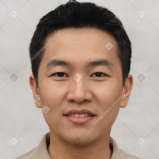 Joyful asian young-adult male with short  black hair and brown eyes