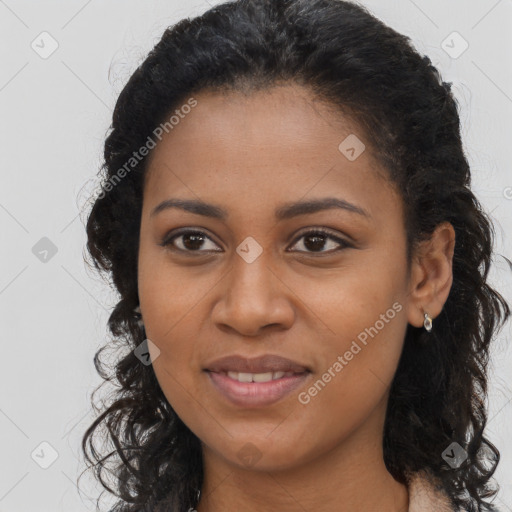 Joyful black young-adult female with long  brown hair and brown eyes