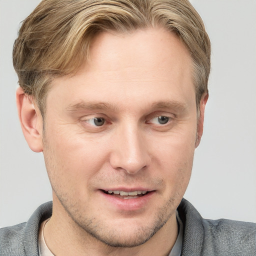 Joyful white young-adult male with short  brown hair and blue eyes