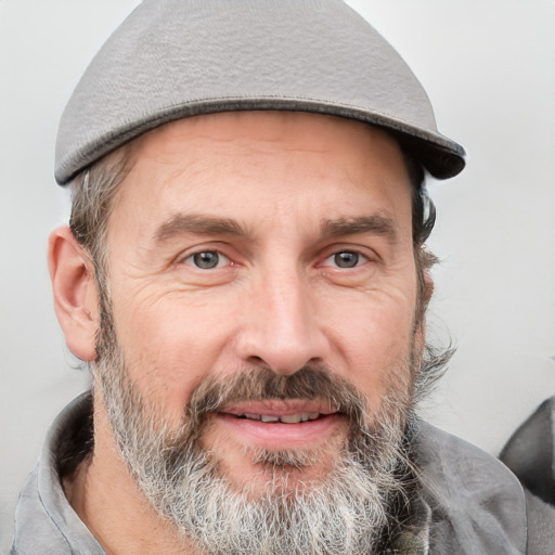 Joyful white adult male with short  brown hair and grey eyes