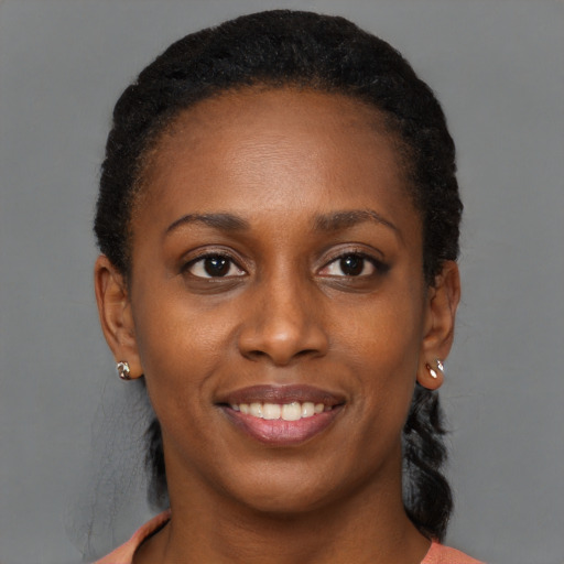 Joyful black young-adult female with short  black hair and brown eyes