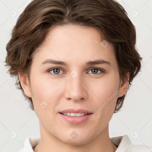 Joyful white young-adult female with short  brown hair and grey eyes