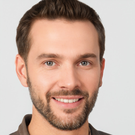 Joyful white young-adult male with short  brown hair and brown eyes