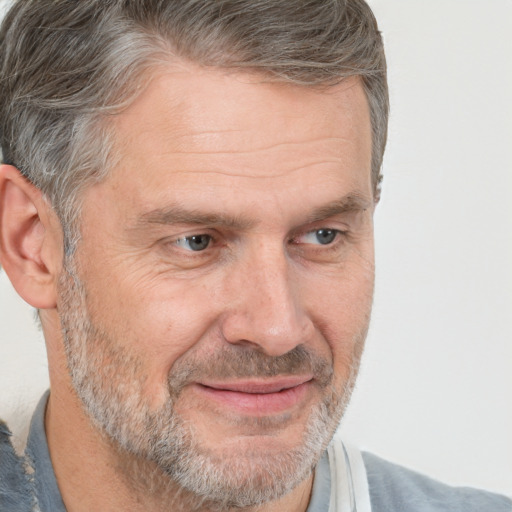 Joyful white middle-aged male with short  brown hair and brown eyes