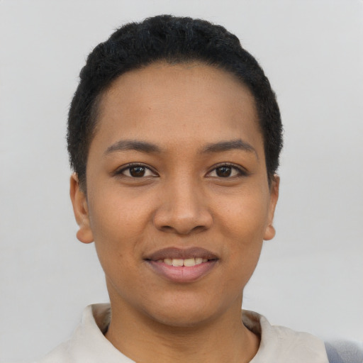 Joyful latino young-adult female with short  black hair and brown eyes
