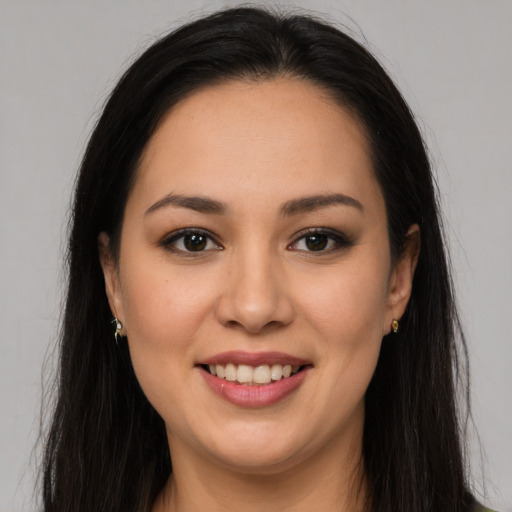 Joyful latino young-adult female with long  brown hair and brown eyes